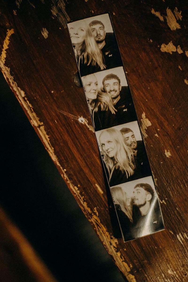 Black-and-white photo booth strip print of a couple